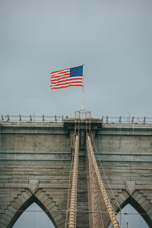 american flag on bridge
