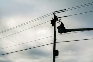 Silhouette of lineworker working on powerlines